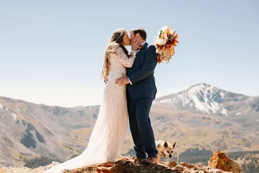 Wedding couple shares their first kiss with stunning mountain views in Colorado