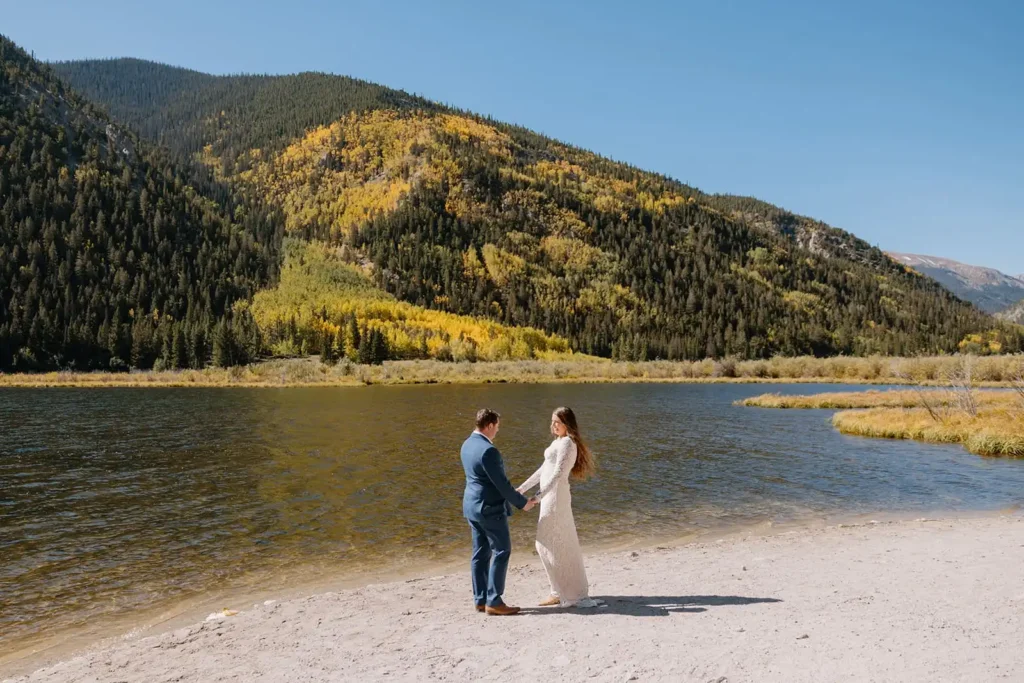 Documentary-style elopement photographer in Colorado photographs private vows at a high alpine lake