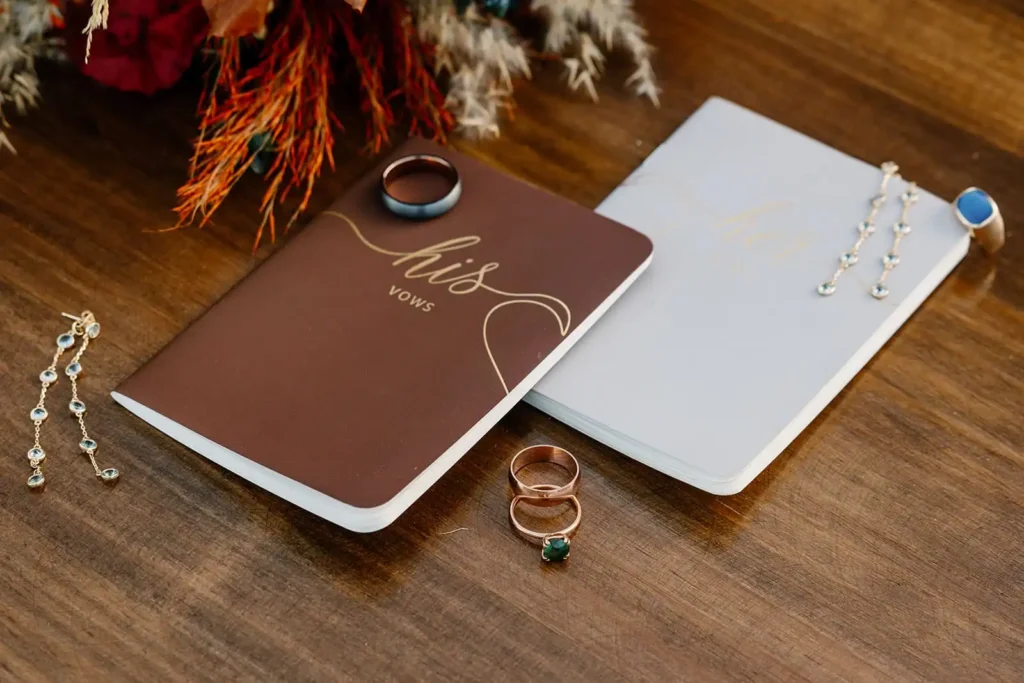 close up of vow books and wedding rings from a Colorado adventure elopement