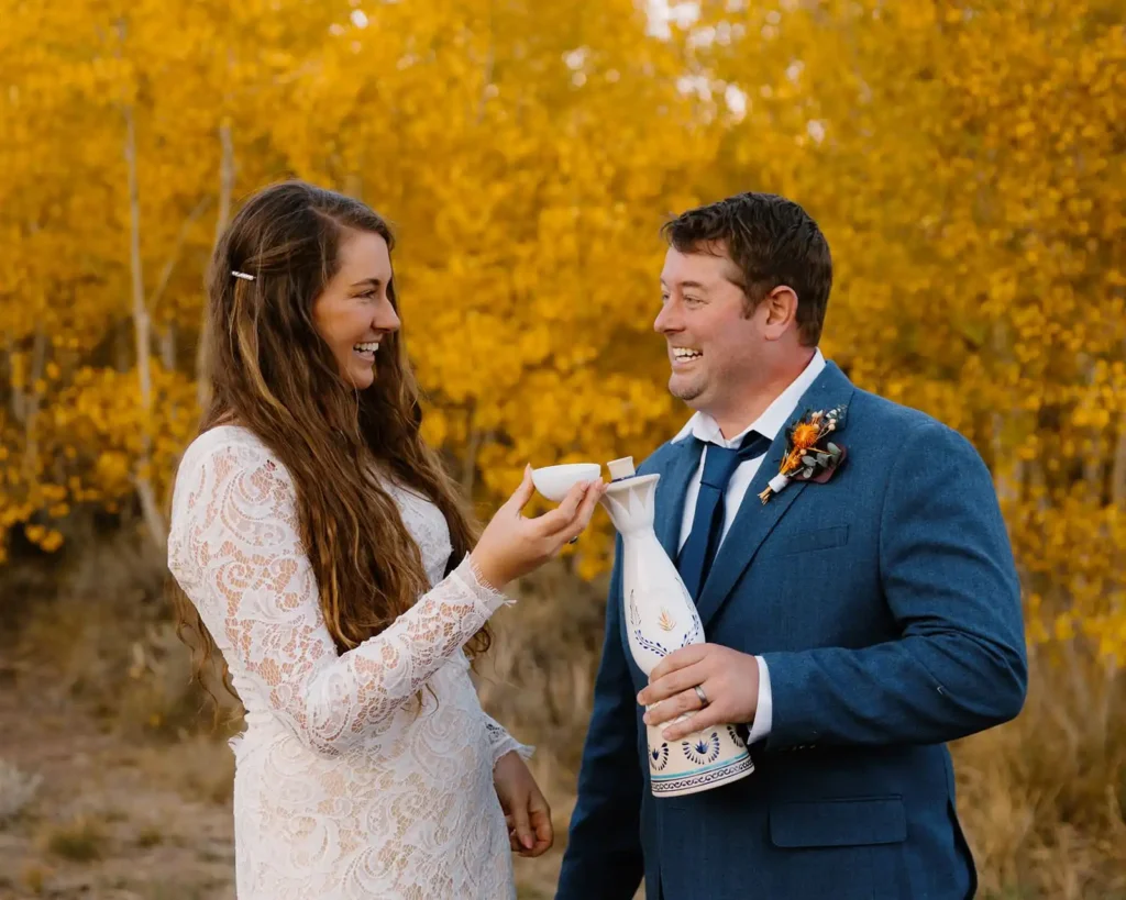 Couple shares a toast on elopement day with clase azul tequila
