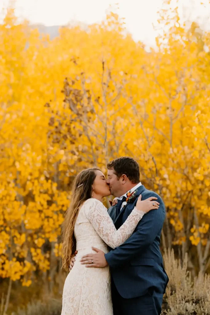 Colorado couple kisses in the golden aspen trees on wedding day in Vail Colorado