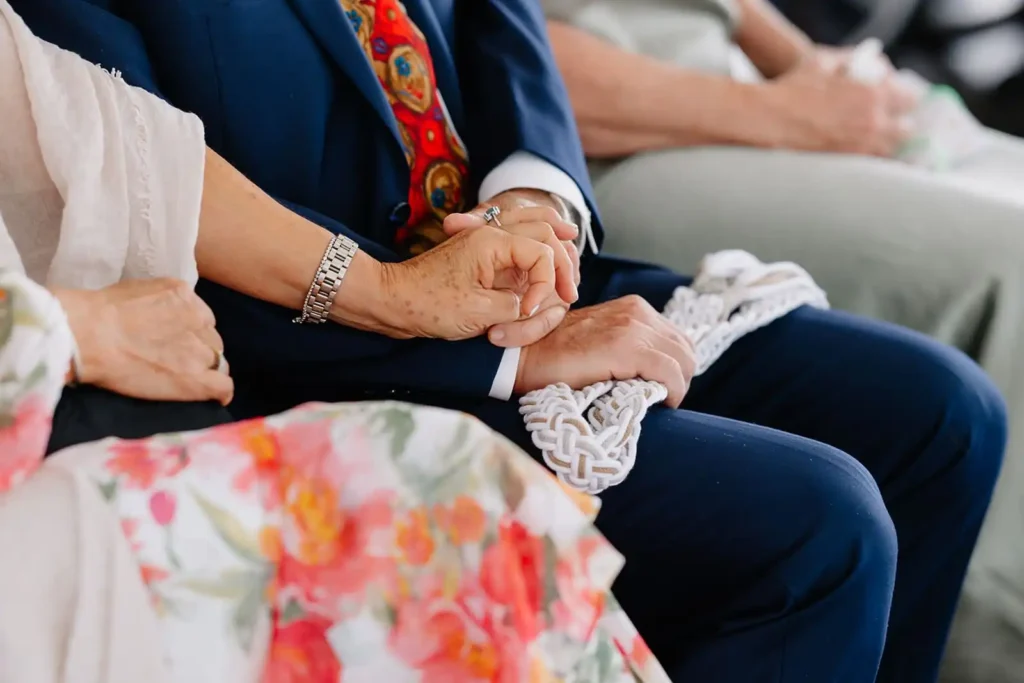Leah Lach a Colorado Documentary Style Wedding Photographer captures sweet candid moment during ceremony at Wellshire Event Center