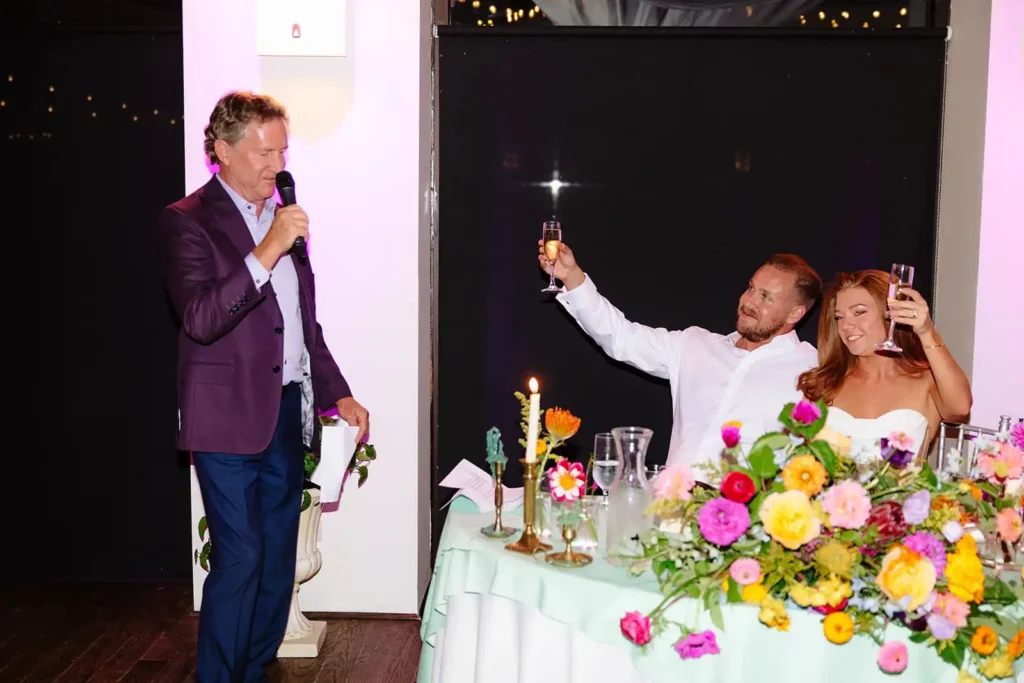 Bride and groom share a toast during their summer Colorado wedding in Denver
