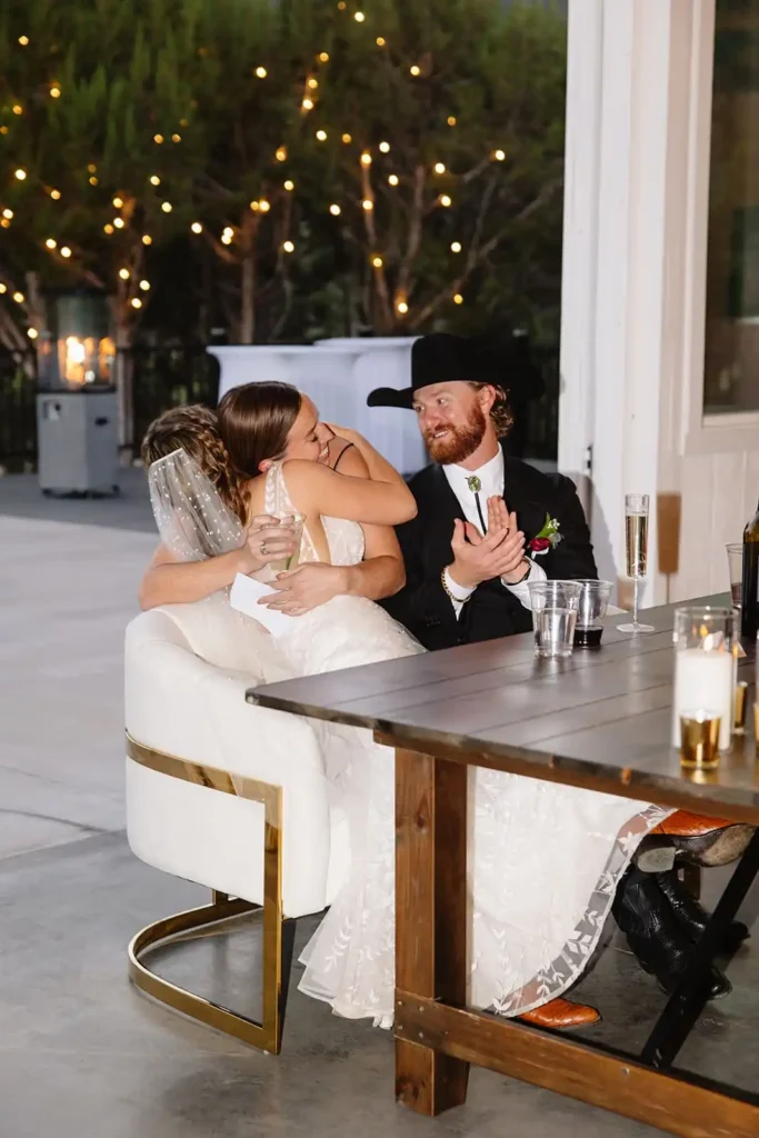 Sweet moment shared between the bride and the maid of honor at modern barn venue in Rifle Colorado