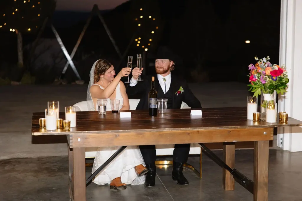 Bride and groom cheers during wedding reception at Vista View Events - an affordable wedding venue near Aspen Colorado.