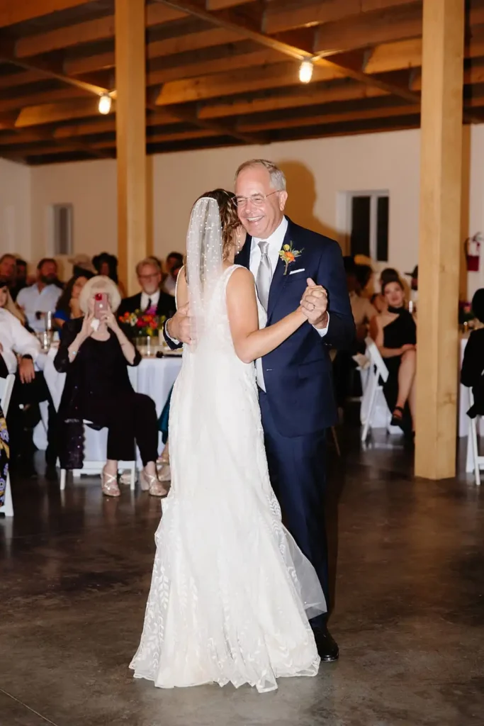 Bride shares a first look dance with her father at Vista View Events. Candid photography taken by Leah Lach