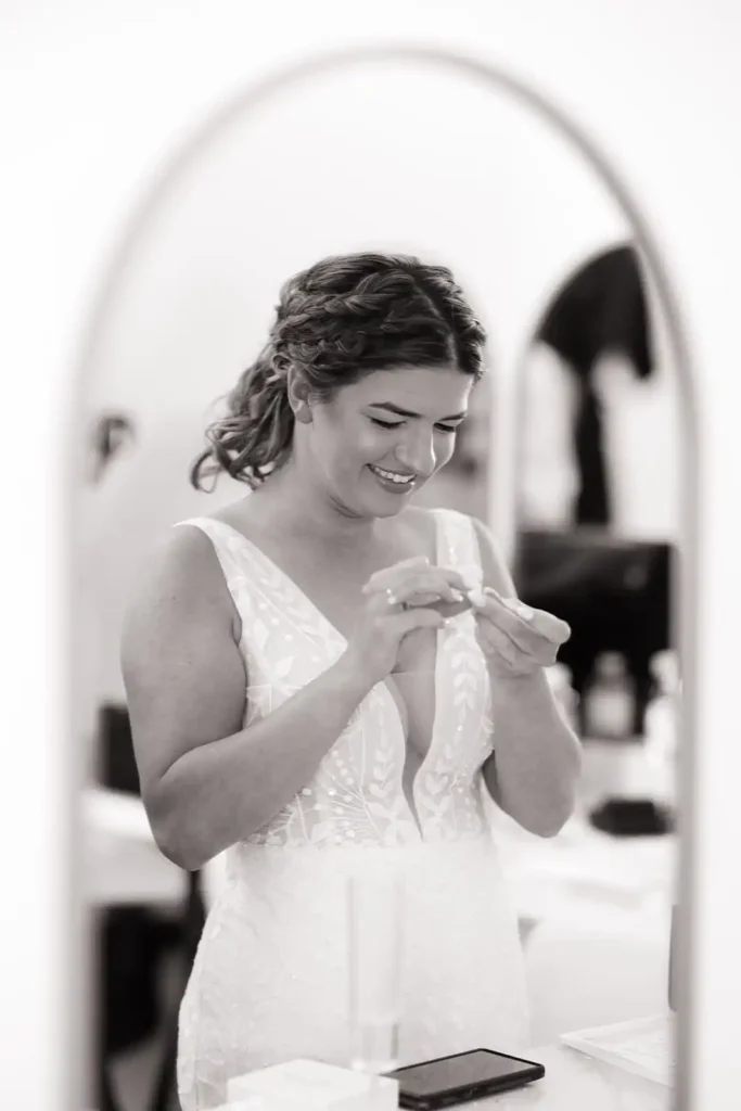 Natural light pouring into the bridal suite as the bride puts on her earrings before her Colorado wedding ceremony.
