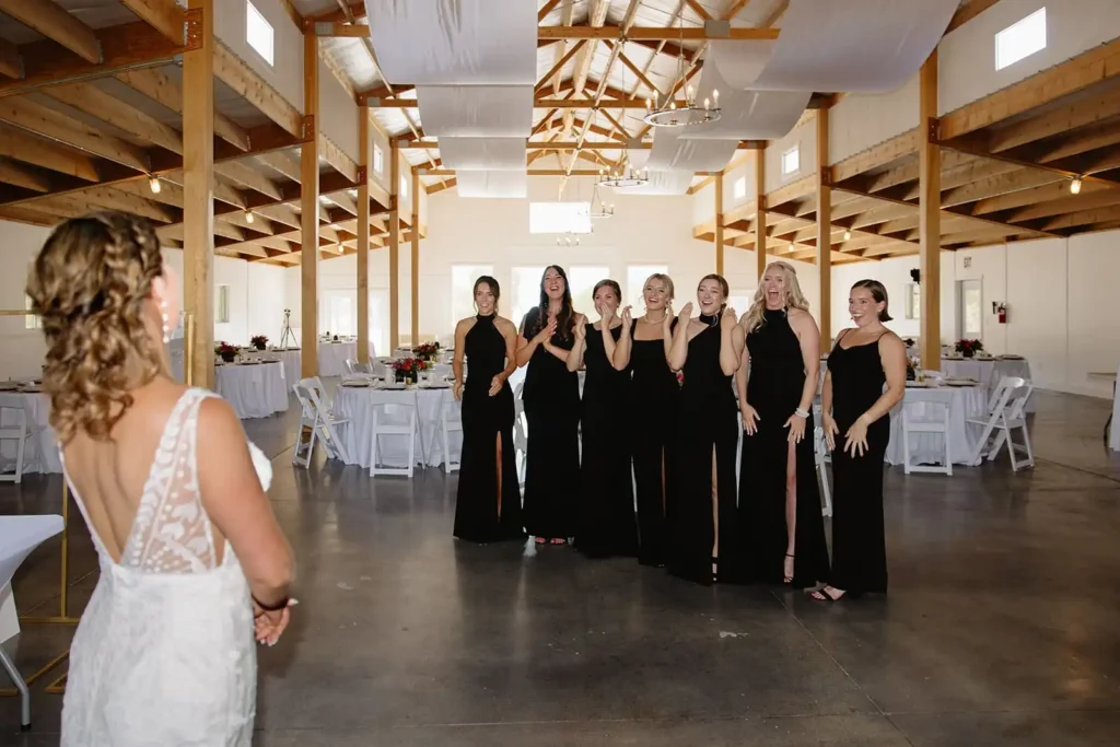 Bridesmaids sharing an emotional first look with the bride at Vista View Events, a modern barn venue with mountain views.