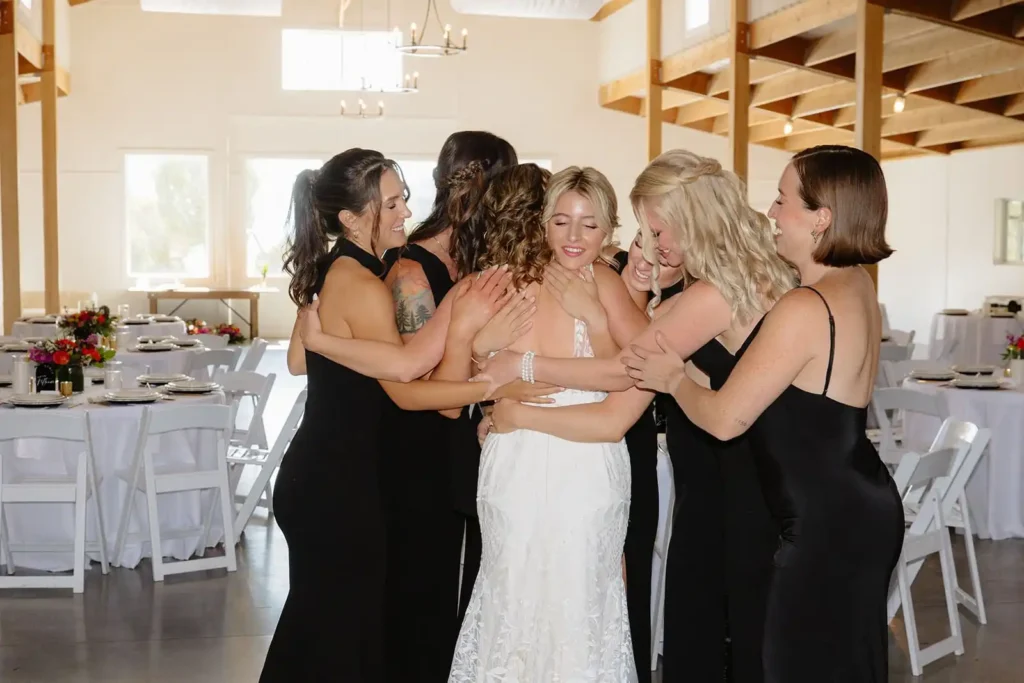 Candid photo of bridesmaids sharing an sweet first look with the bride at Vista View Events, a wedding venue near Aspen Colorado