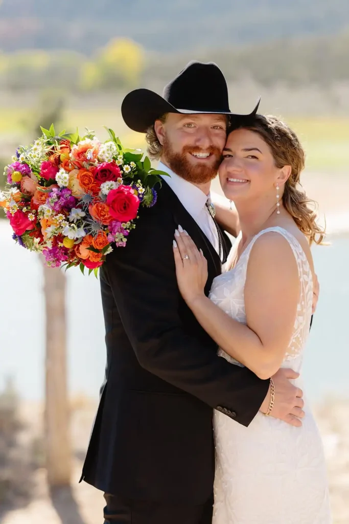 Bride smiling up at groom during first look in rustic wedding setting in the Colorado mountains.