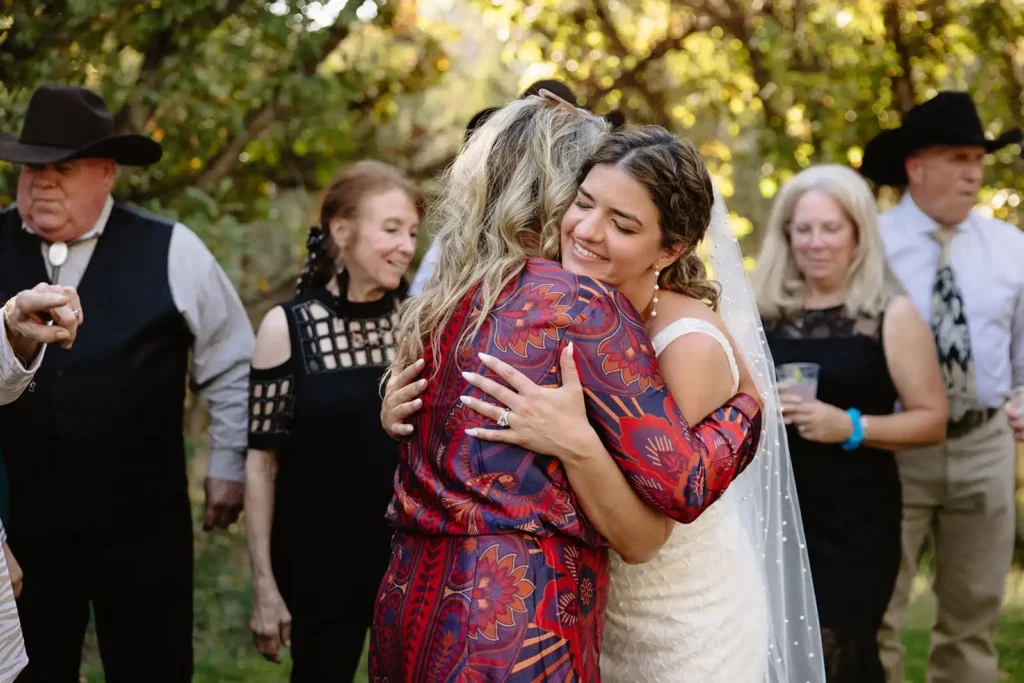 Bride enjoying candid moment with her guests during cocktail hour. Inspiration for a western-style wedding