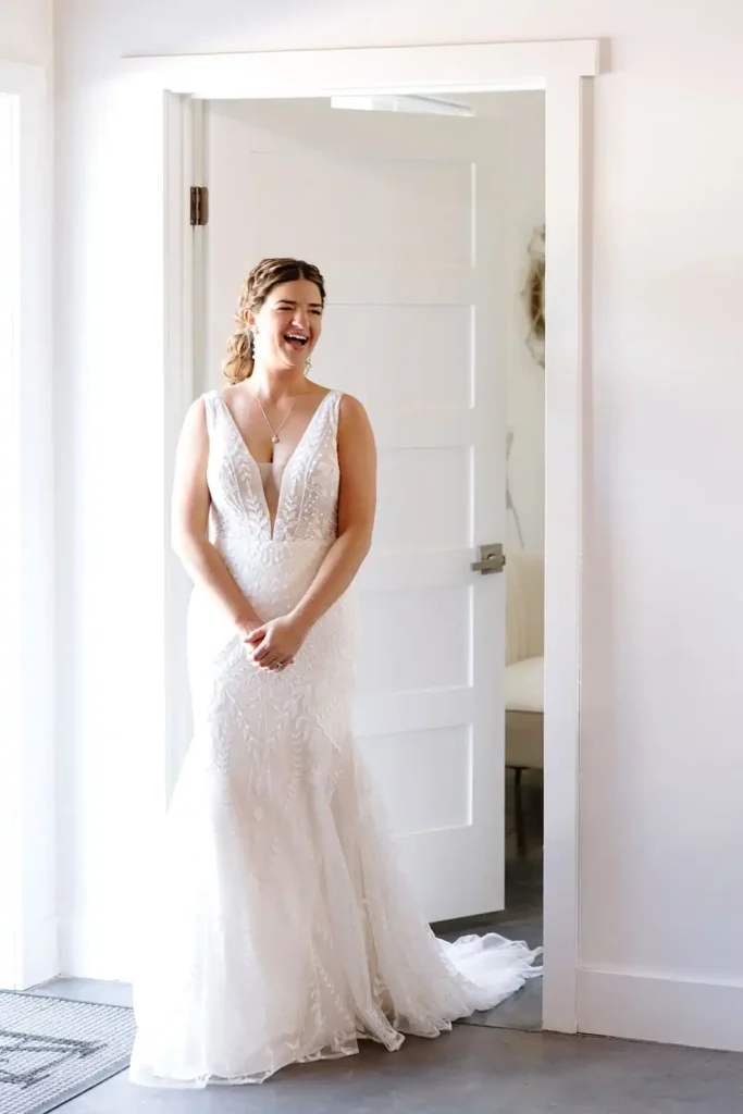 Bride smiling before a first look moment at Vista View Events - a modern barn wedding venue in Colorado with lake views